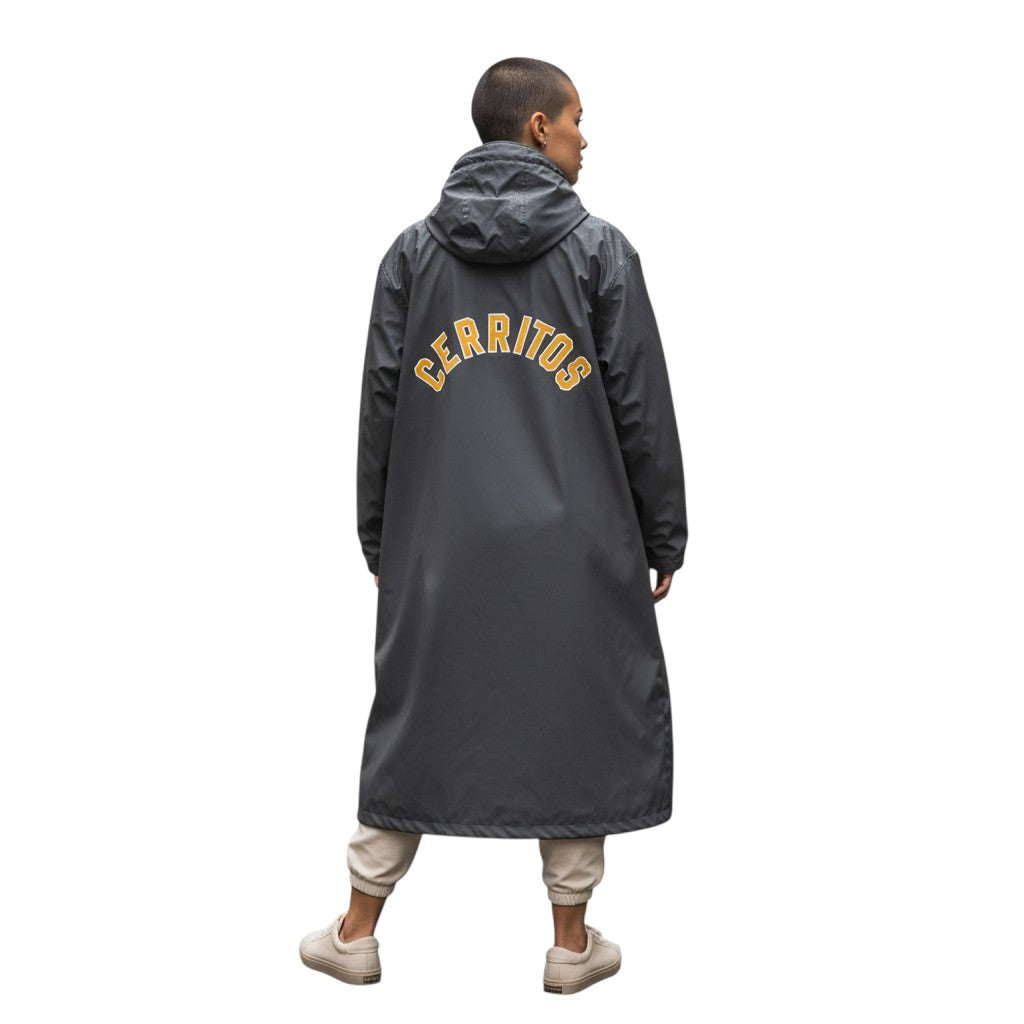 The Swim Guy Online Store black hooded parka with gold Cerritos lettering on the back, worn by a model outdoors.